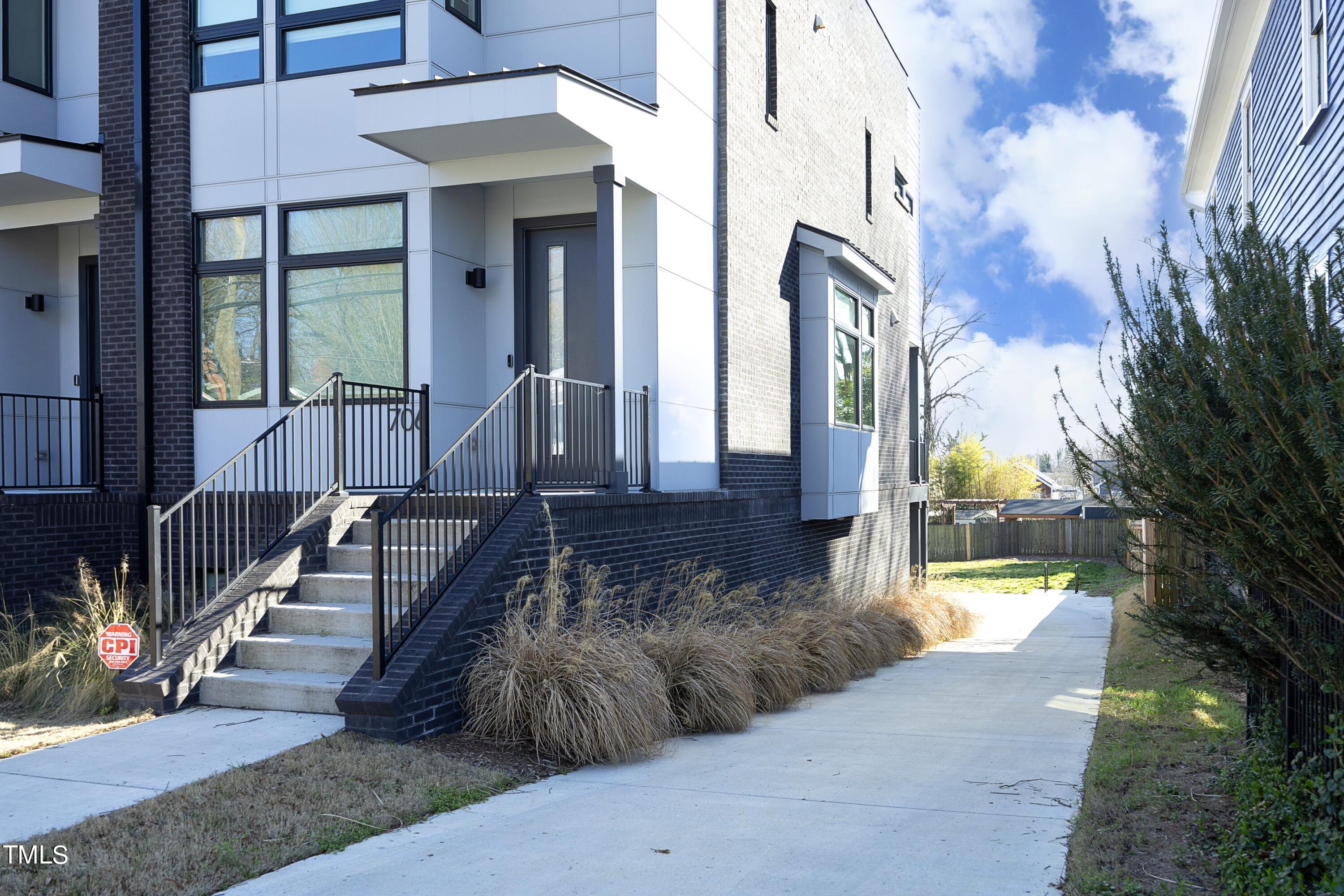 706 East Hargett Street Raleigh, NC 27601 - Photo 2 of 35 a view of a house with a large tree and many windows