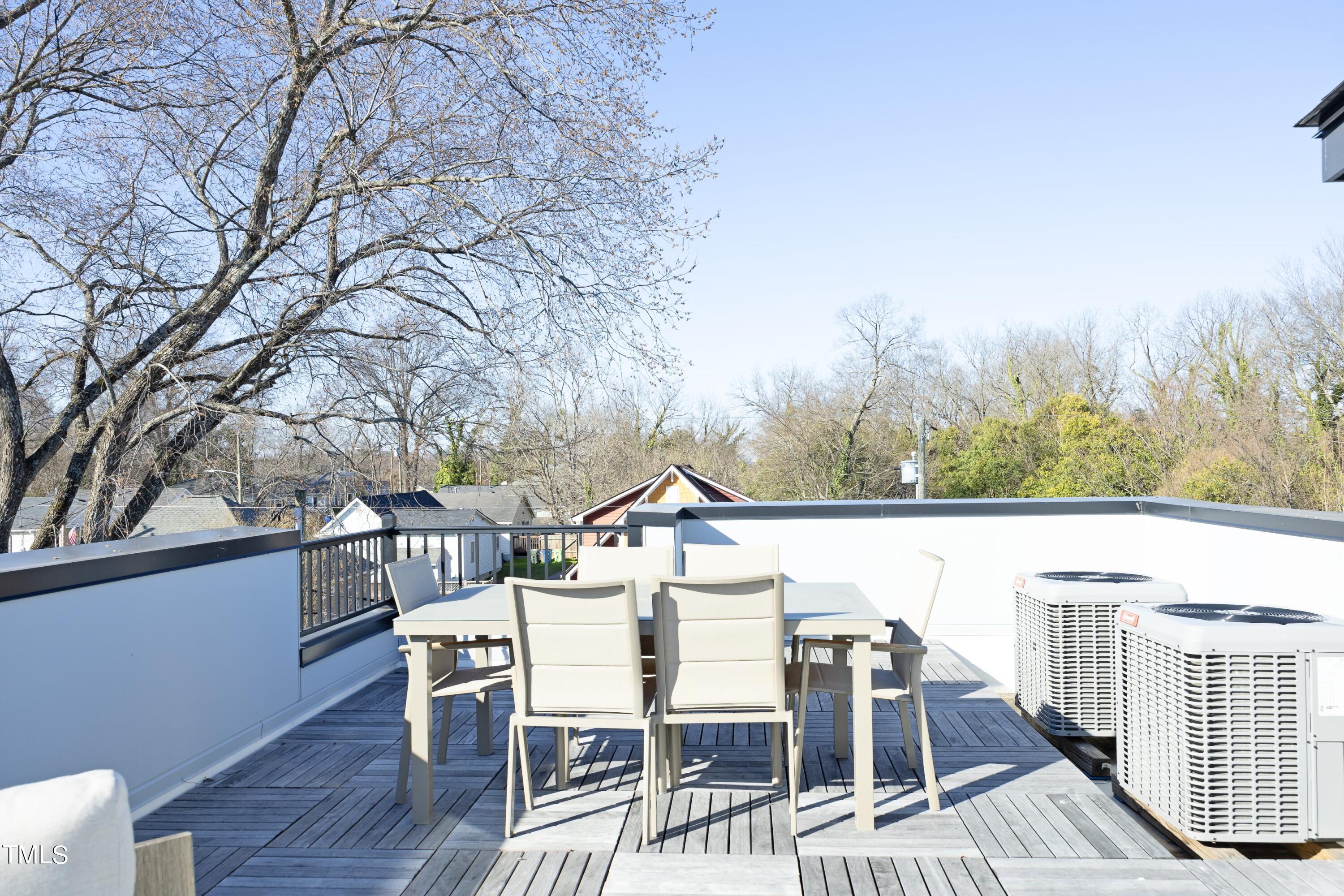 706 East Hargett Street Raleigh, NC 27601 - Photo 24 of 35 a view of a patio with table and chairs and couches with wooden floor and fence
