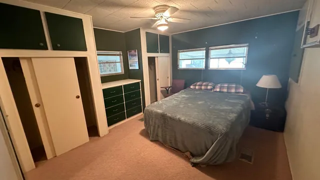 a bedroom with a bed window and walk in closet