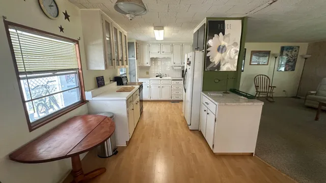 a room with furniture a large window and wooden floor
