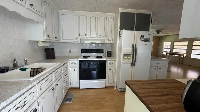 a kitchen with stainless steel appliances a refrigerator sink and cabinets