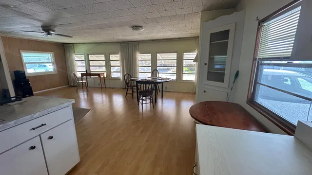a dining room with furniture and wooden floor