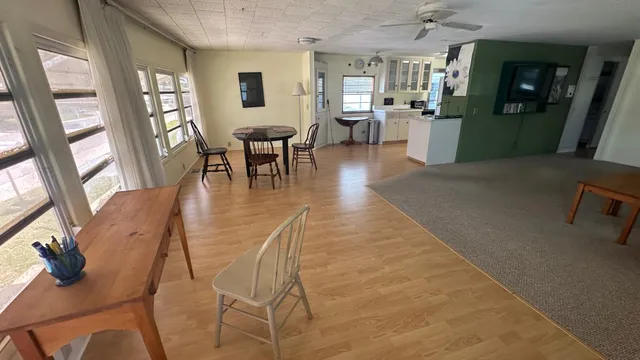 a view of a livingroom with furniture window and wooden floor