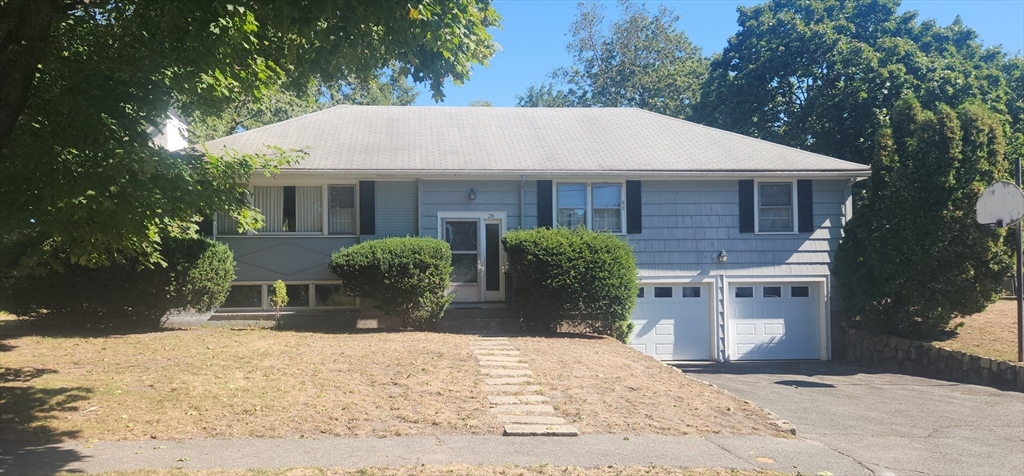 28 Poplar Road Wellesley, MA 02482 - Photo 1 of 4 a front view of a house with a yard and garage