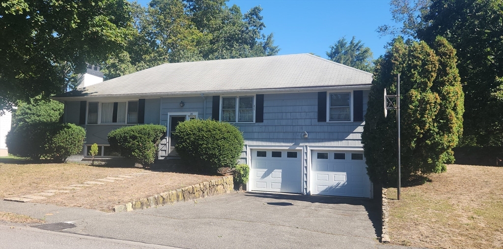 28 Poplar Road Wellesley, MA 02482 - Photo 2 of 4 a view of a house with a yard and potted plants