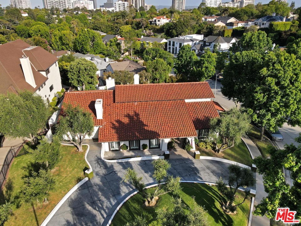 an aerial view of a house with yard swimming pool and lake view