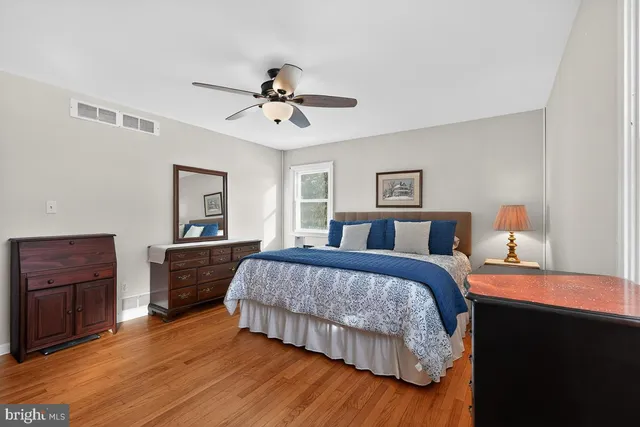 a bedroom with a bed and flat screen tv