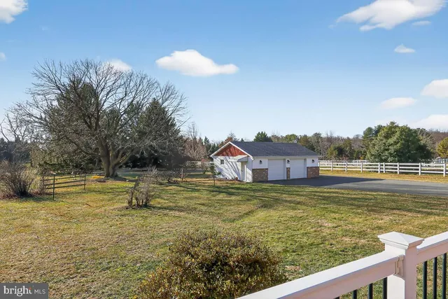 a view of a house with yard and sitting area