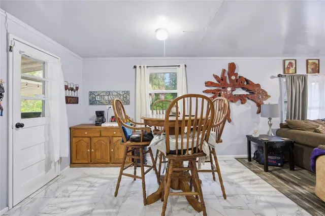 a view of a livingroom with furniture and a window
