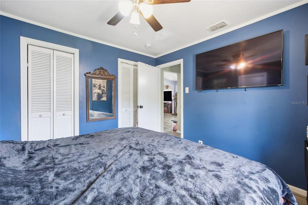 5403 East Tangelo Lane Inverness, FL 34453 - Photo 18 of 32 a bedroom with a bed and a flat screen tv