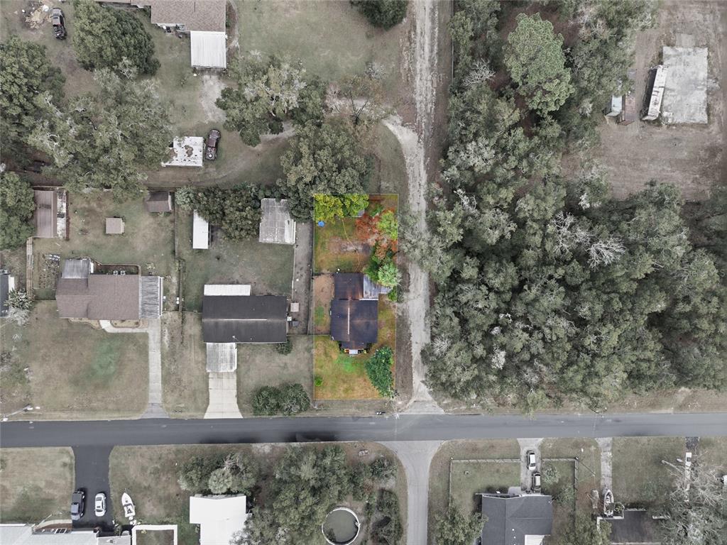 5403 East Tangelo Lane Inverness, FL 34453 - Photo 25 of 32 an aerial view of a residential apartment building with a yard and parking spaces