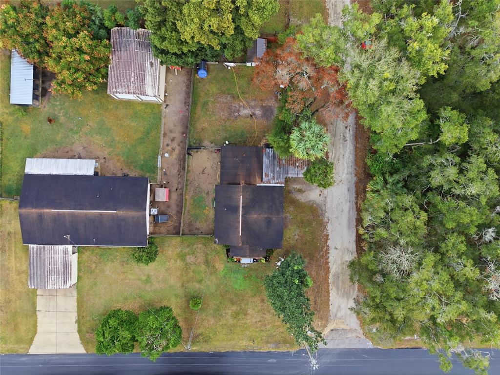 5403 East Tangelo Lane Inverness, FL 34453 - Photo 27 of 32 an aerial view of a house with garden space and a yard