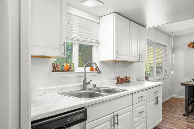 a kitchen with a sink cabinets and window