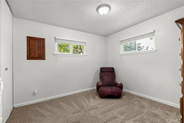 an empty room with wooden floor and cabinet