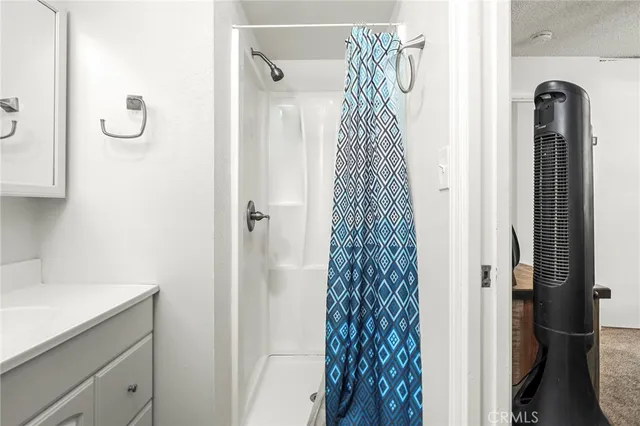 a bathroom with a shower curtain and a sink