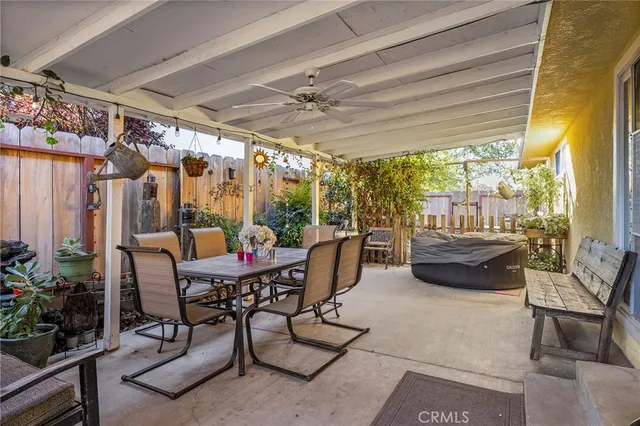 a dining room with furniture and a floor to ceiling window