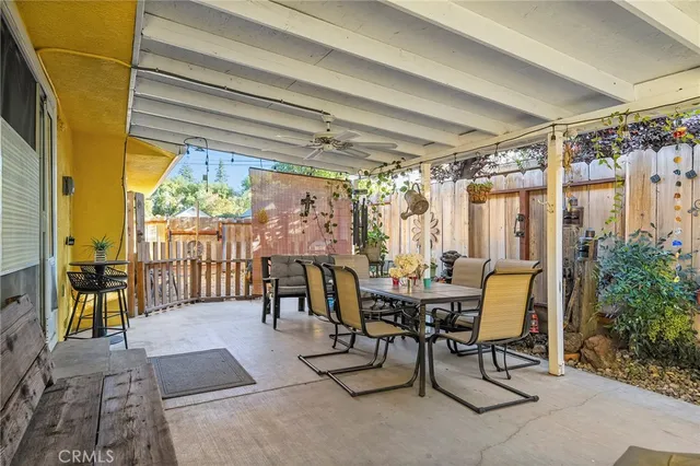 a view of a dining room with furniture and a potted plant