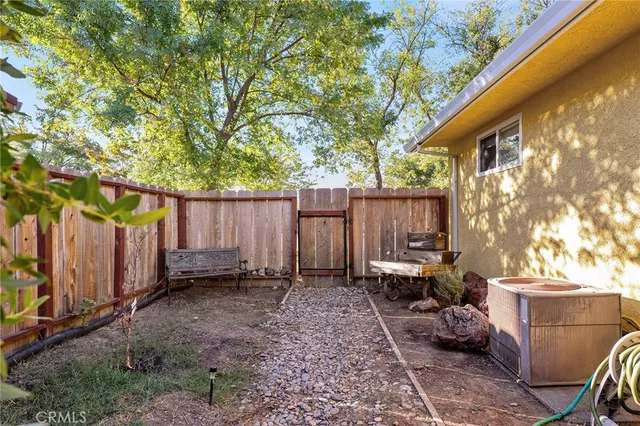 a backyard of a house with lots of green space and glass windows