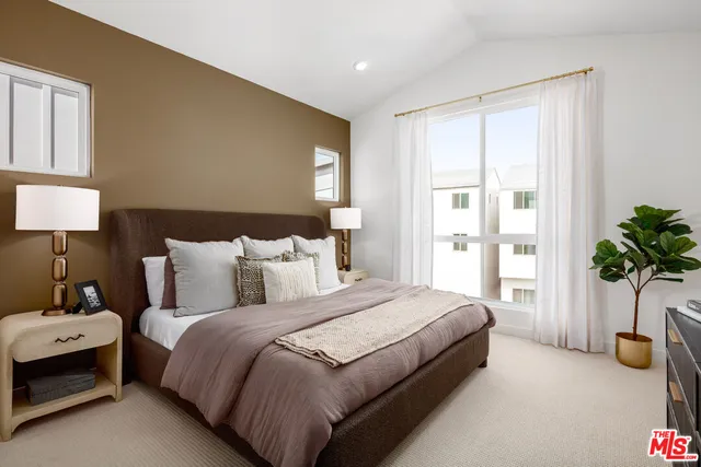 a bedroom with bed and a window