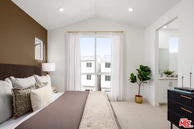 a bed room with a bed and a potted plant