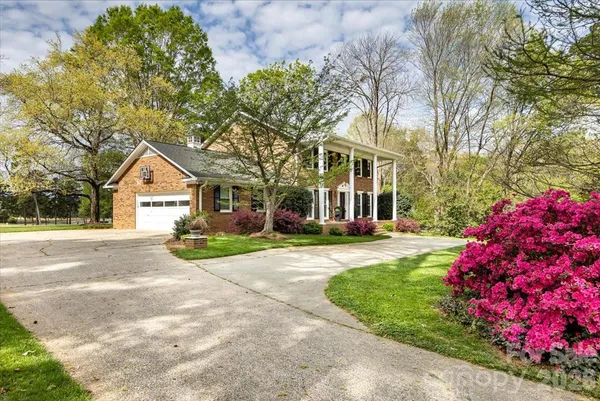 a front view of a house with a yard and pathway