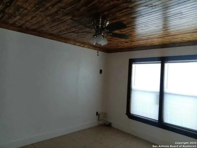 a view of a ceiling fan and a window