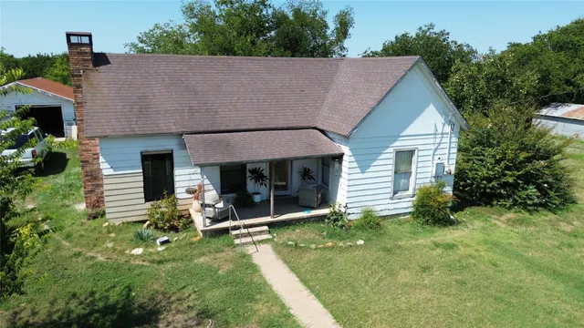 a view of a house with pool and garden