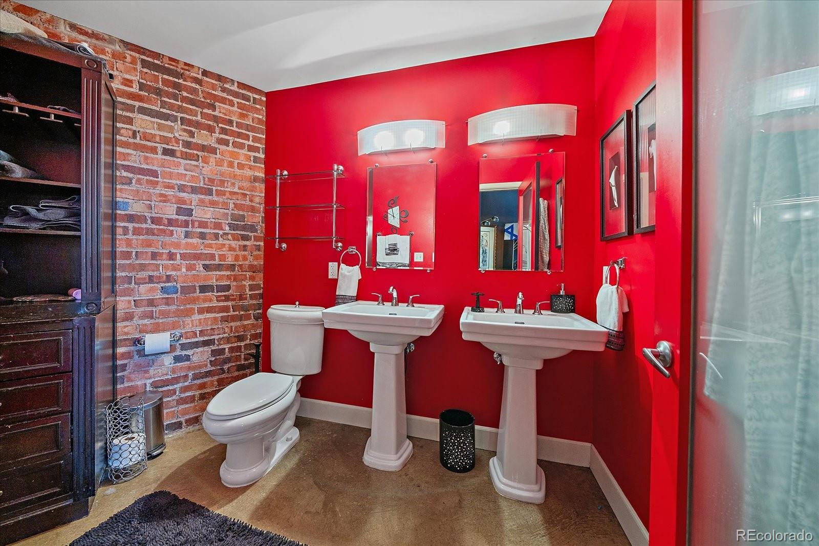2500 Walnut Street, Unit 202 Denver, CO 80205 - Photo 20 of 31 a bathroom with a toilet mirror and vanity