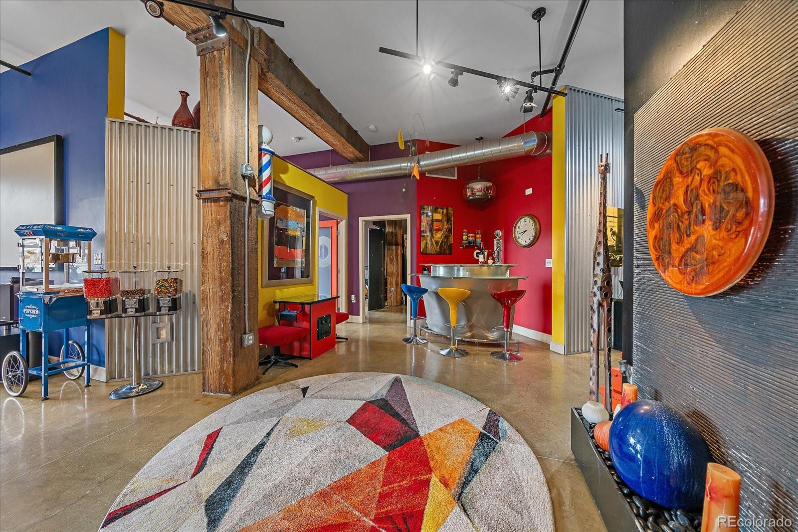 2500 Walnut Street, Unit 202 Denver, CO 80205 - Photo 4 of 31 a bed room with a bed mirror and a chandelier