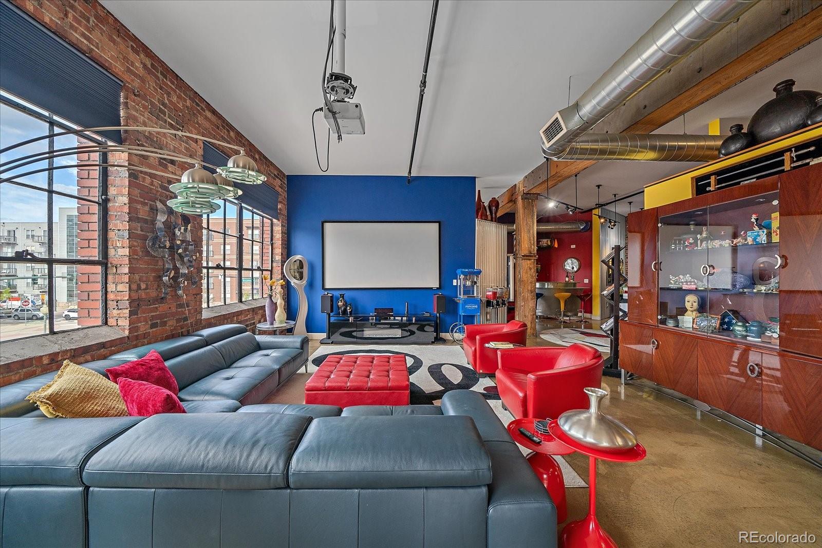 2500 Walnut Street, Unit 202 Denver, CO 80205 - Photo 7 of 31 a living room with furniture a flat screen tv and a chandelier