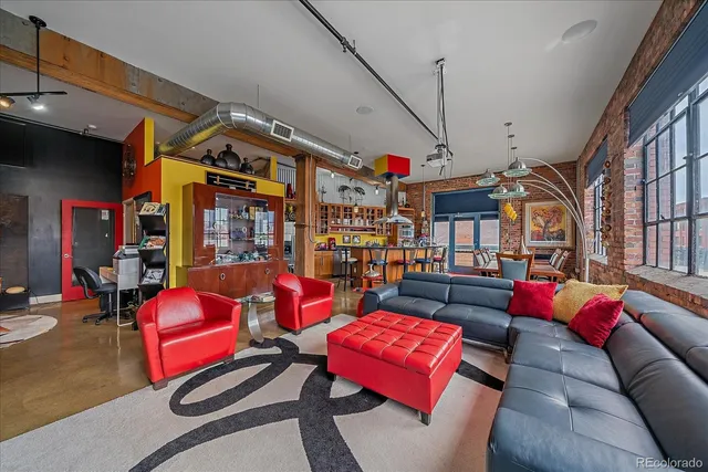 a dining hall with stainless steel appliances granite countertop a dining table and chairs with wooden floor