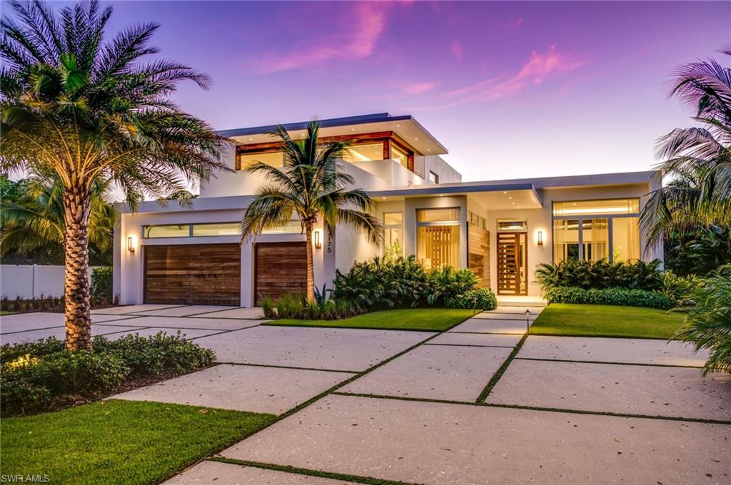 a front view of house with yard and green space