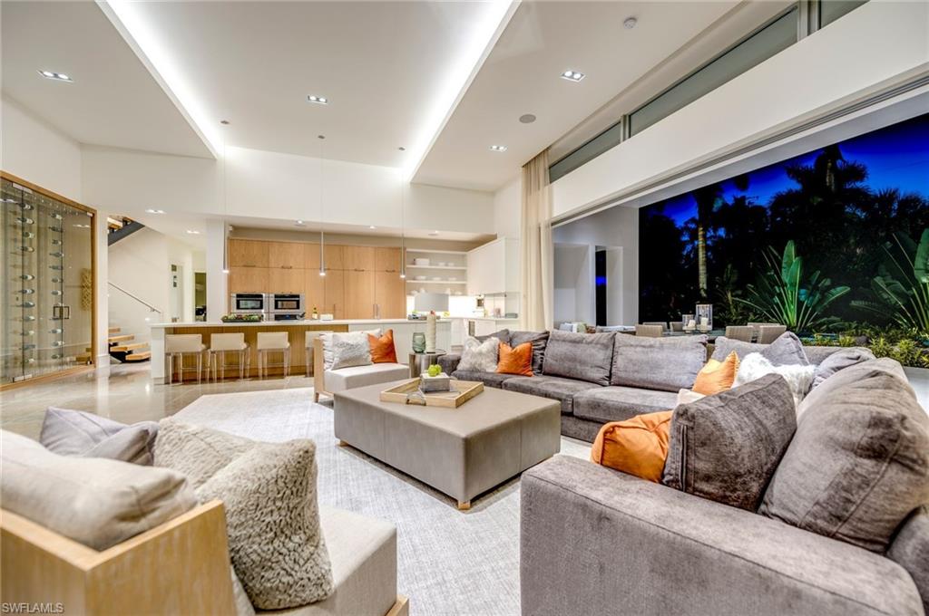 2175 Crayton Road Naples, FL 34103 - Photo 11 of 34 a living room with furniture kitchen view and a large window