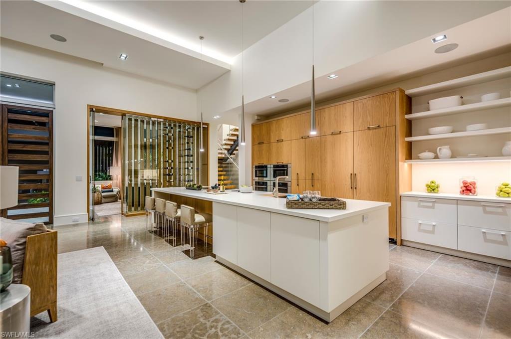 2175 Crayton Road Naples, FL 34103 - Photo 14 of 34 a kitchen with appliances a sink and counter top space