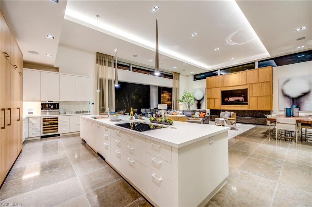 2175 Crayton Road Naples, FL 34103 - Photo 15 of 34 a large kitchen with stainless steel appliances and a large window