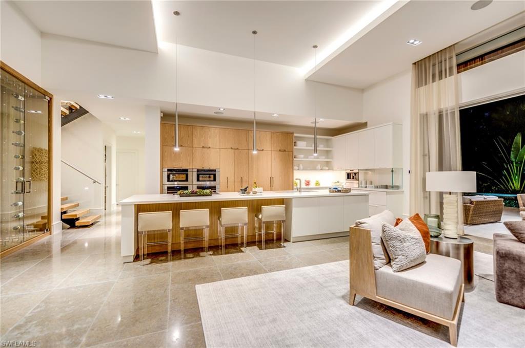 2175 Crayton Road Naples, FL 34103 - Photo 16 of 34 a living room with stainless steel appliances kitchen island granite countertop furniture and a kitchen view