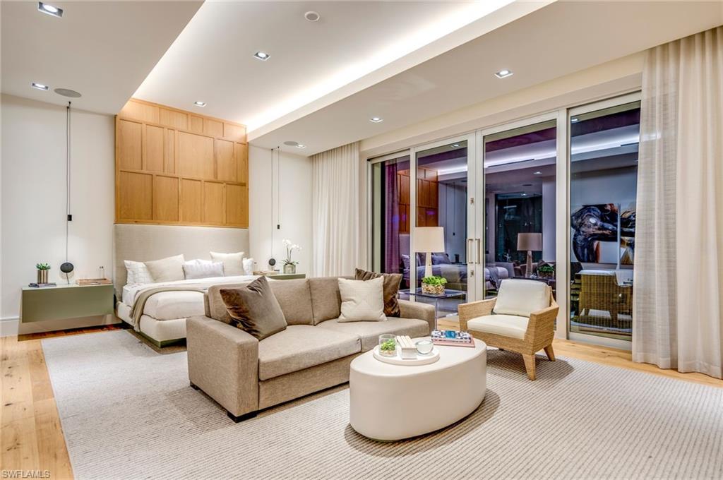 2175 Crayton Road Naples, FL 34103 - Photo 17 of 34 a living room with furniture and a large window