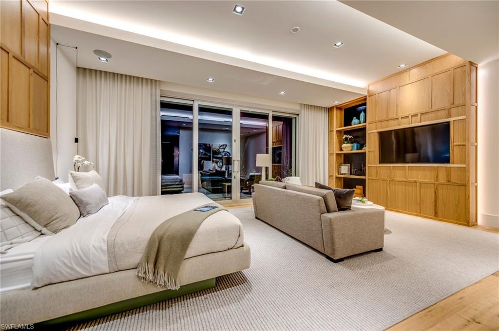 2175 Crayton Road Naples, FL 34103 - Photo 18 of 34 a spacious bedroom with a bed and a couch