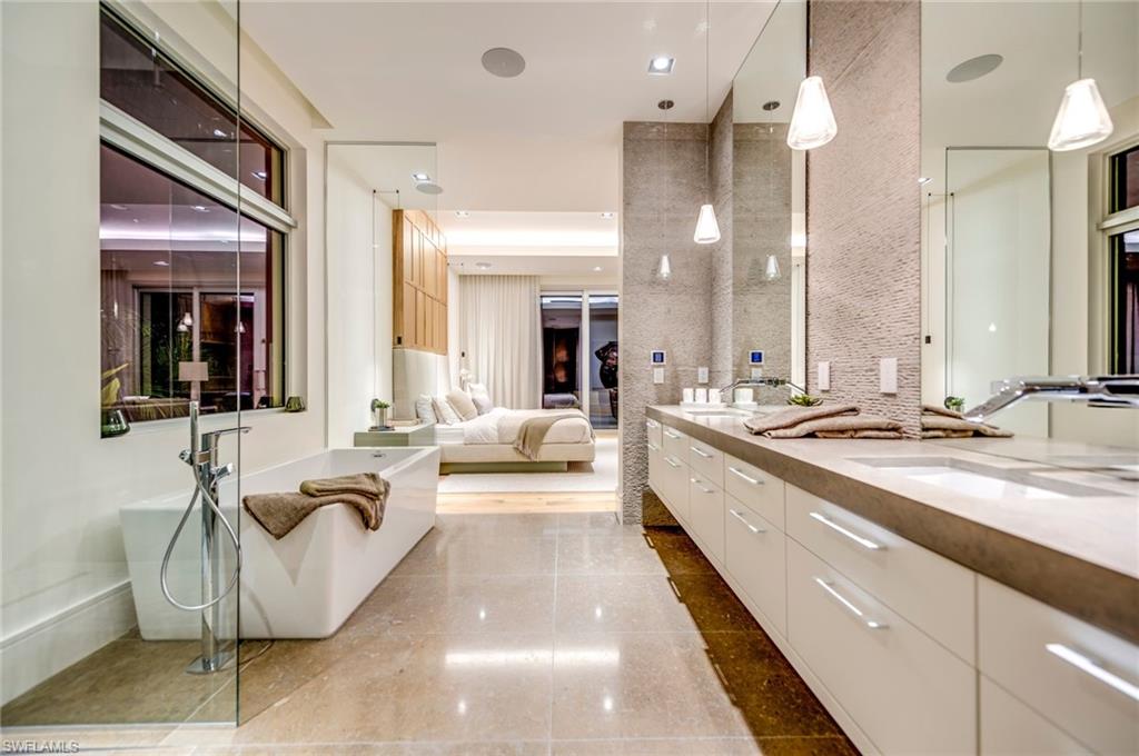 2175 Crayton Road Naples, FL 34103 - Photo 19 of 34 a large white kitchen with a large tub and sink