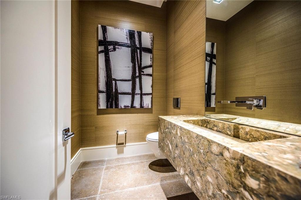 2175 Crayton Road Naples, FL 34103 - Photo 21 of 34 a spacious bathroom with a tub sink and mirror