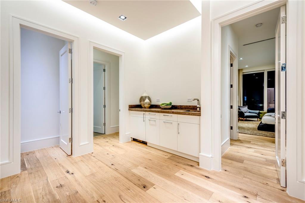 2175 Crayton Road Naples, FL 34103 - Photo 24 of 34 a view of a kitchen from the hallway