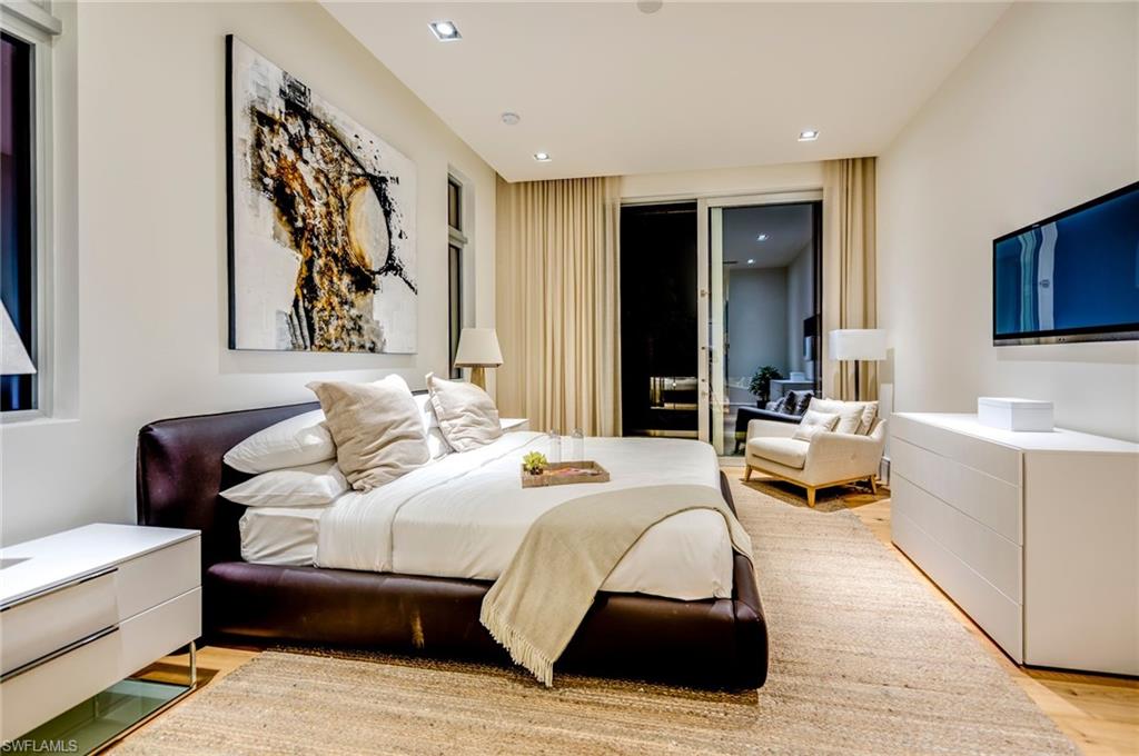 2175 Crayton Road Naples, FL 34103 - Photo 28 of 34 a bedroom with a bed and a couch