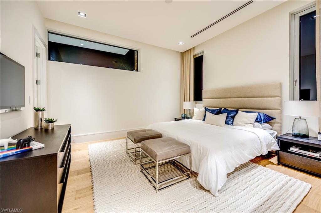 2175 Crayton Road Naples, FL 34103 - Photo 30 of 34 a bedroom with a bed and a flat screen tv