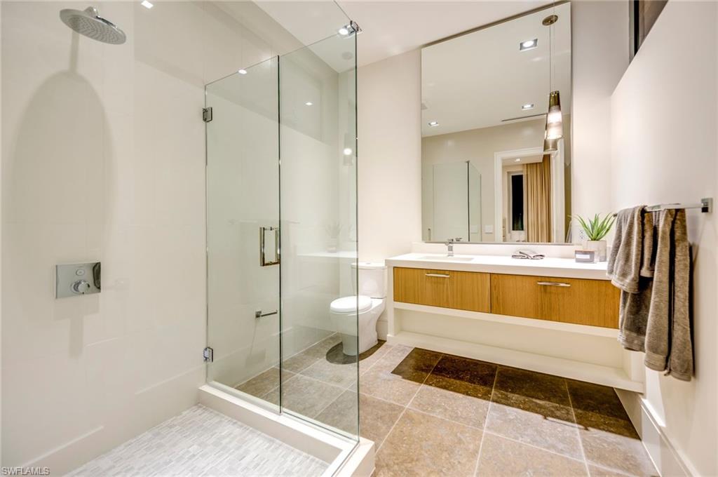 2175 Crayton Road Naples, FL 34103 - Photo 31 of 34 a bathroom with a double vanity sink mirror and toilet