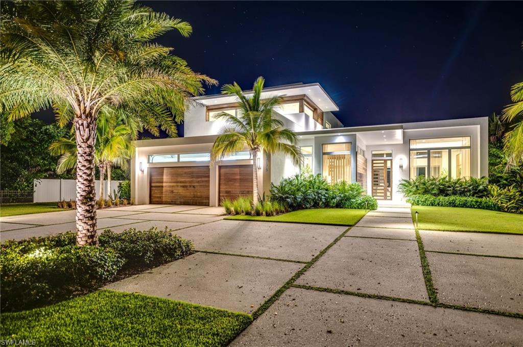 2175 Crayton Road Naples, FL 34103 - Photo 34 of 34 a view of a brick house with a yard and large tree