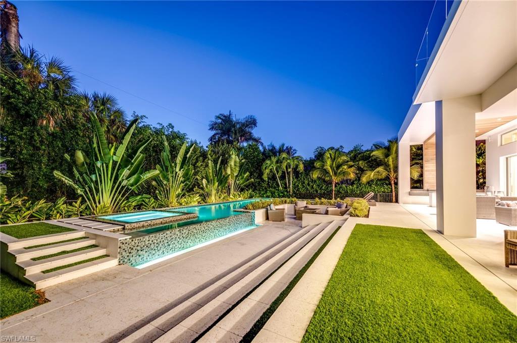 2175 Crayton Road Naples, FL 34103 - Photo 8 of 34 a view of a backyard with swimming pool