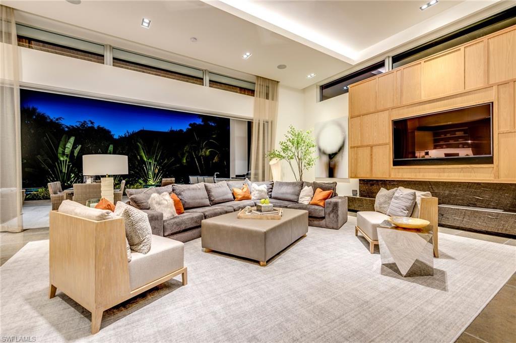 2175 Crayton Road Naples, FL 34103 - Photo 10 of 34 a living room with fireplace furniture and a large window