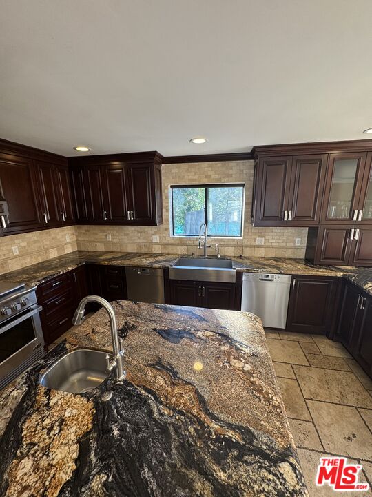 5515 Ruthwood Drive Calabasas, CA 91302 - Photo 22 of 48 a kitchen with granite countertop a sink a stove and cabinets