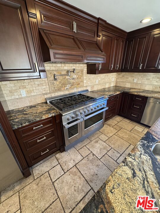 5515 Ruthwood Drive Calabasas, CA 91302 - Photo 23 of 48 a kitchen with a stove and a cabinet