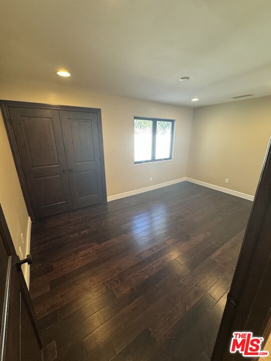 5515 Ruthwood Drive Calabasas, CA 91302 - Photo 26 of 48 an empty room with wooden floor and windows